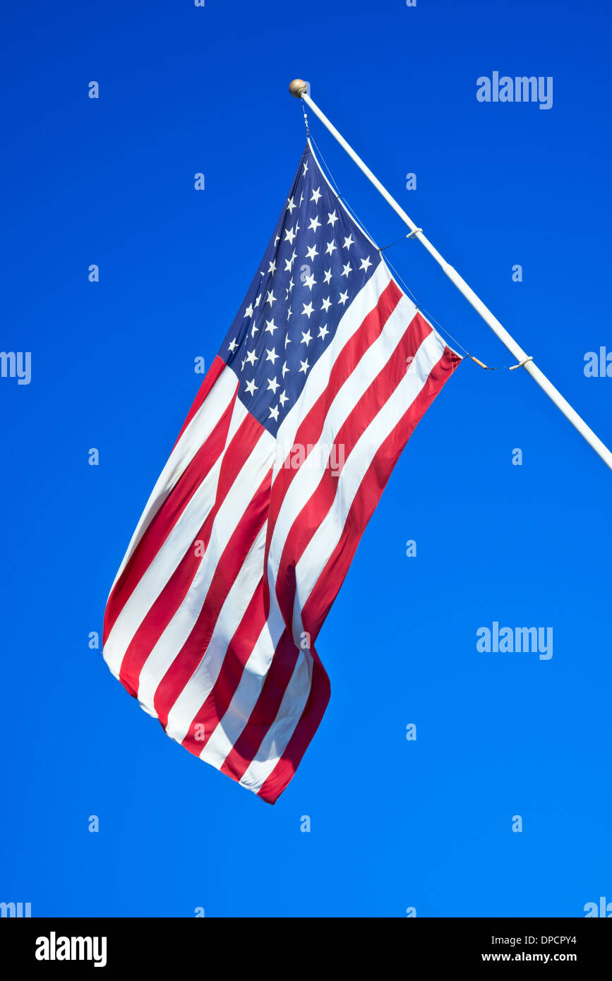 American flag against bright blue sky Stock Photo - Alamy