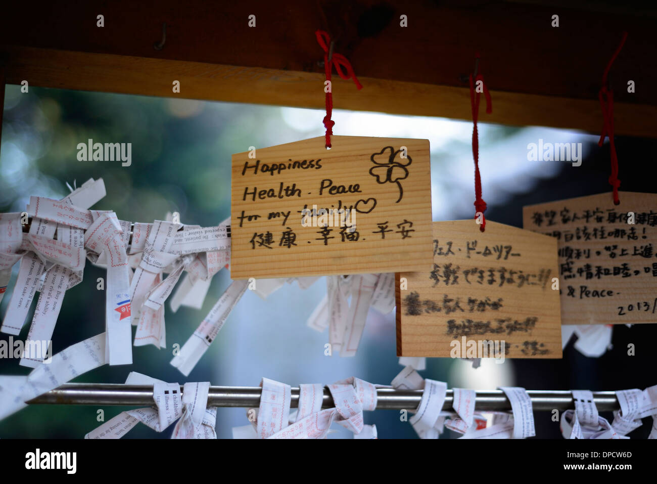 happiness health peace for my family wish pray prayer wood wooden omikuji prayers fortune fortunes buddhist temple tokyo japan Stock Photo