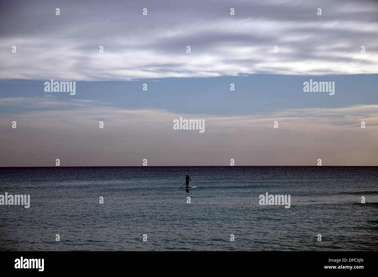 A surfer paddles in Nissi beach in Ayia Napa,Cyprus on January 9,2014 Stock Photo
