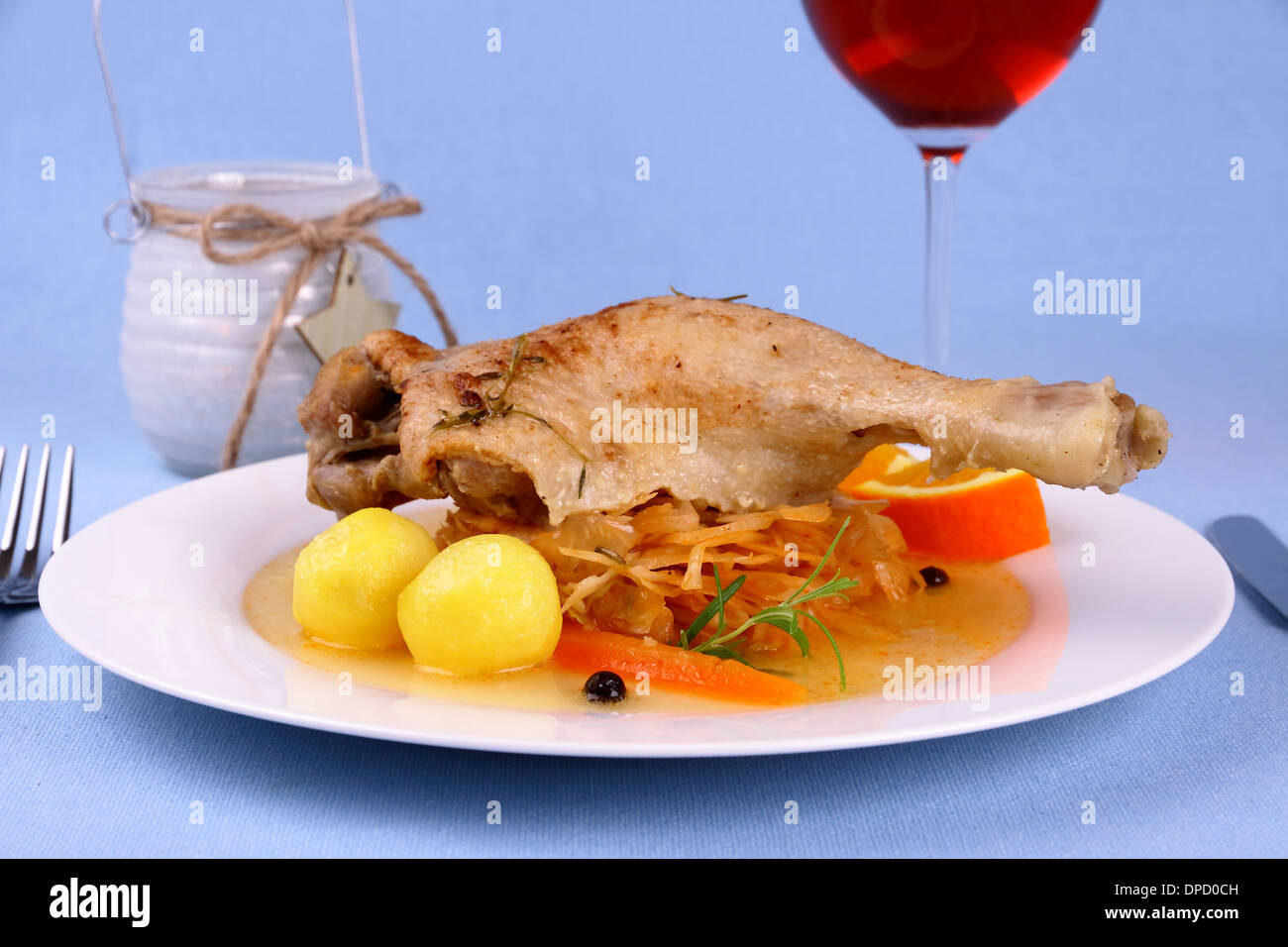 Duck leg with braised cabbage, potato and gravy, close up Stock Photo