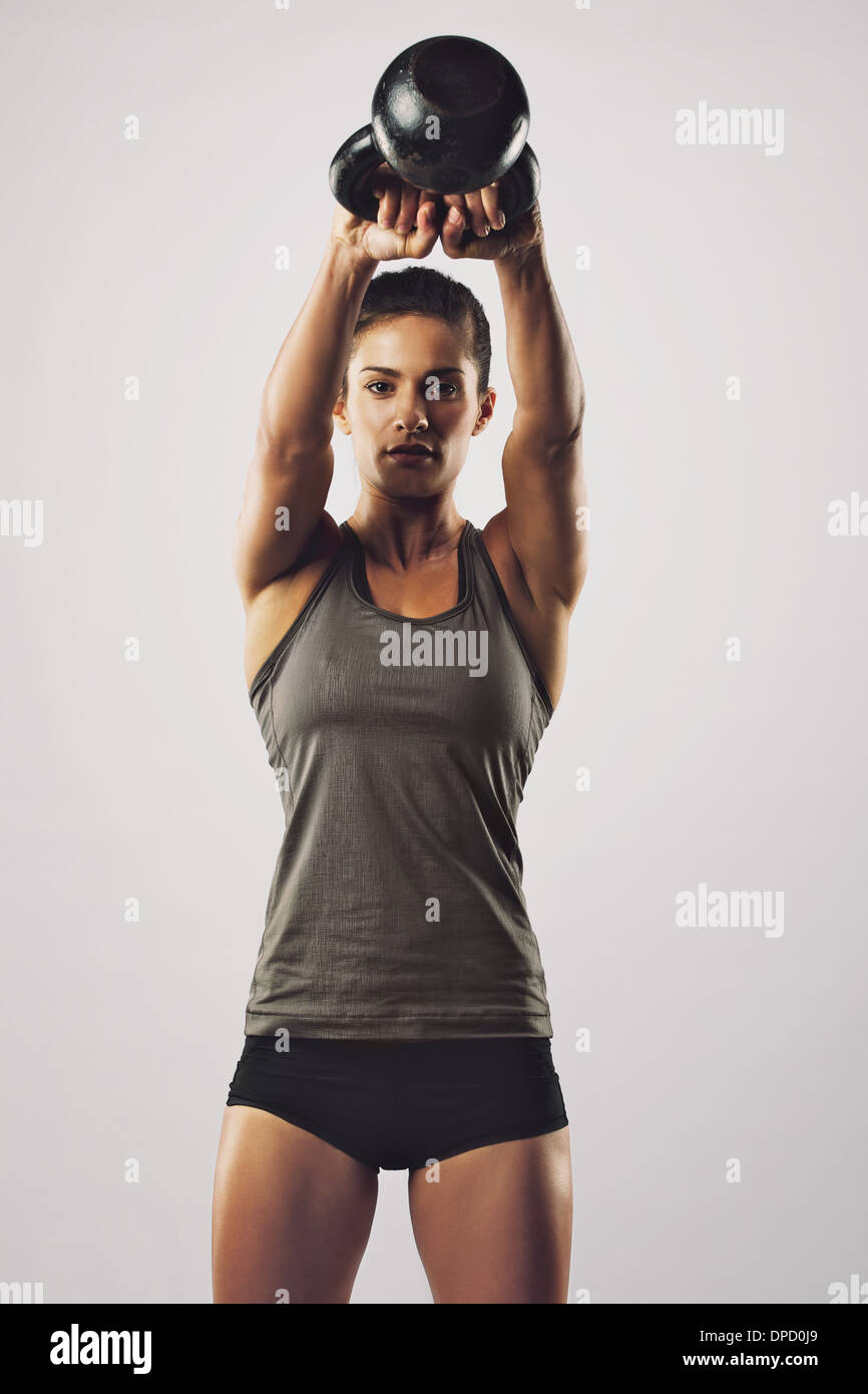 Beautiful Young Woman Training With Kettlebell In Gym Stock Photo