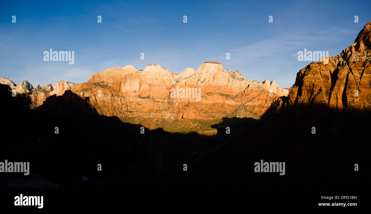 The light has not quite reached the valley int this vertical composition of early morning in the desert Southwest Stock Photo