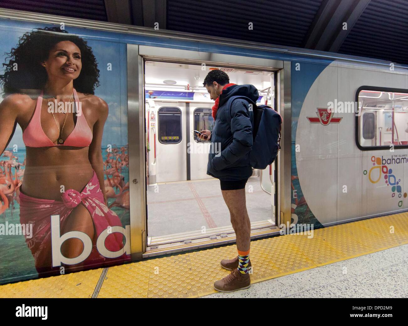 Toronto. 12th Jan, 2014. A man without pant reads on his smartphone while waiting for subway at a station during the 2014 No Pants Subway Ride in Toronto, Jan. 12, 2014. More than 200 people took part in this activity here on Sunday. Credit:  Zou Zheng/Xinhua/Alamy Live News Stock Photo
