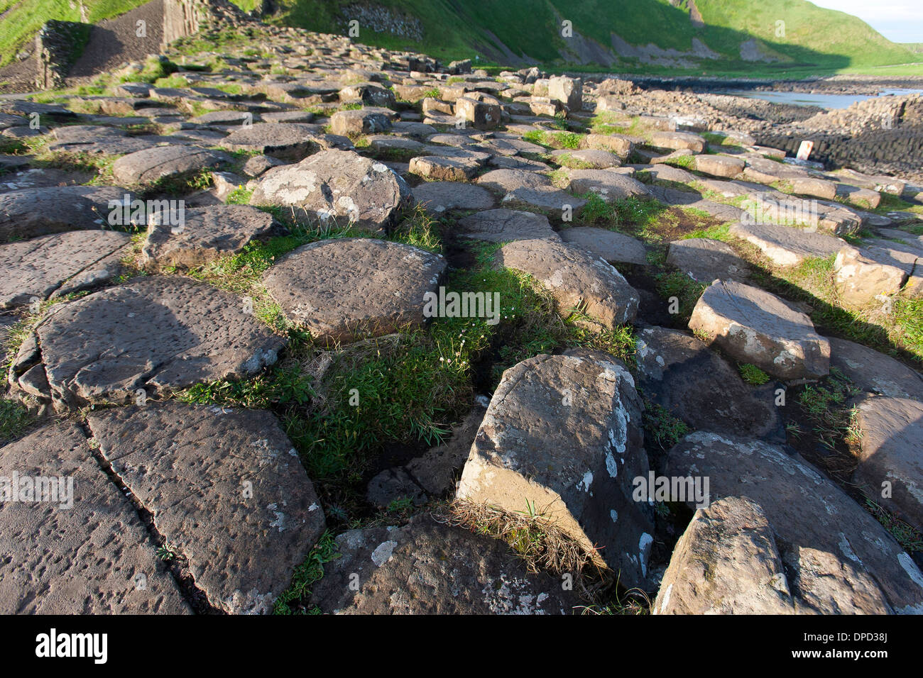 A wide view of the basalt columns that make up the world famous Giants Causeway in County Antrim and close by coastline. Stock Photo