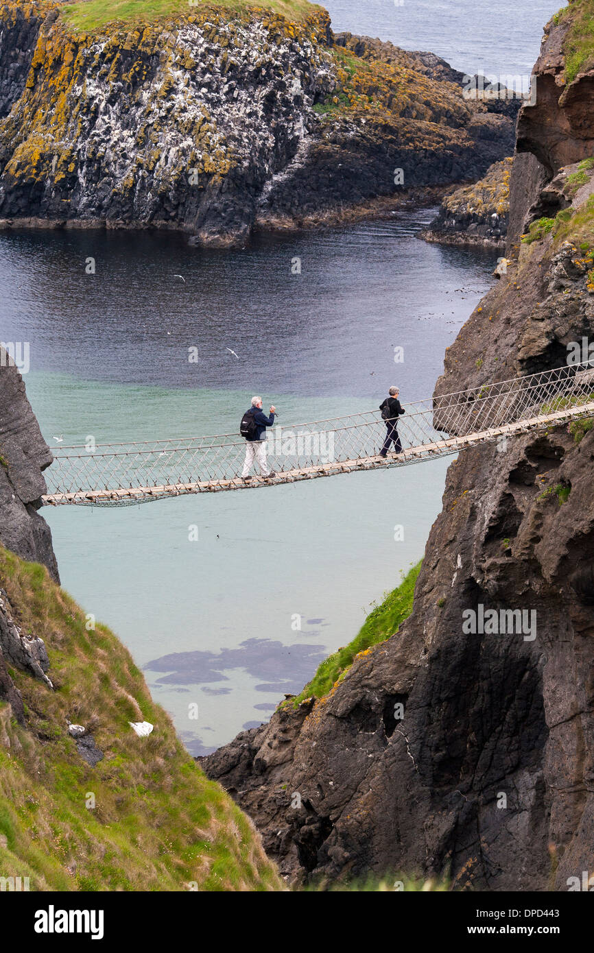 Looking down from above the Carrick-a-Rede rope bridge on the Antrim coast  of Northern Ireland as a visitor walks across Stock Photo - Alamy