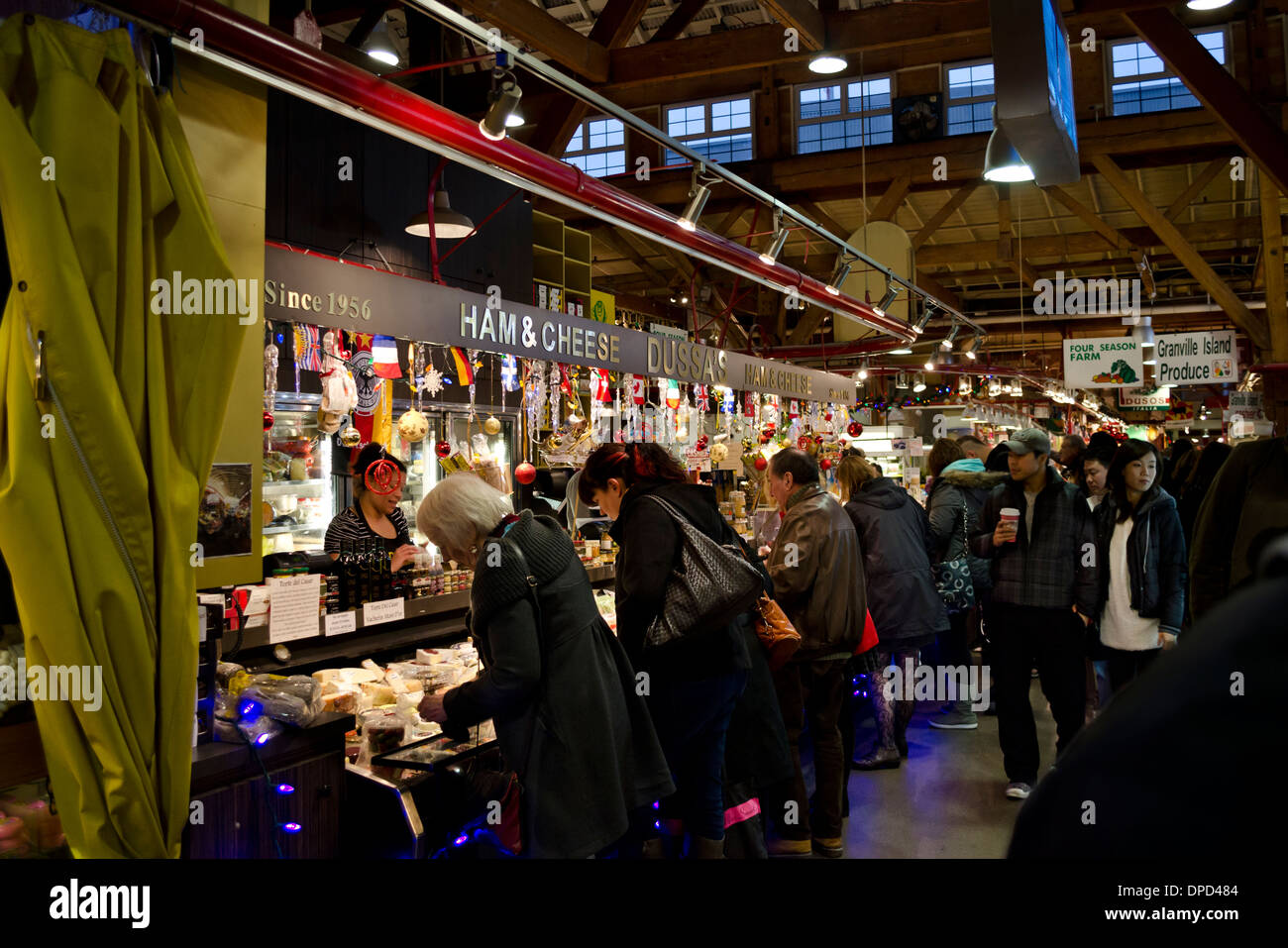 Busy holiday shoppers during the Christmas season at Granville Island Public Market in Vancouver. Dussa's Italian gourmet foods Stock Photo