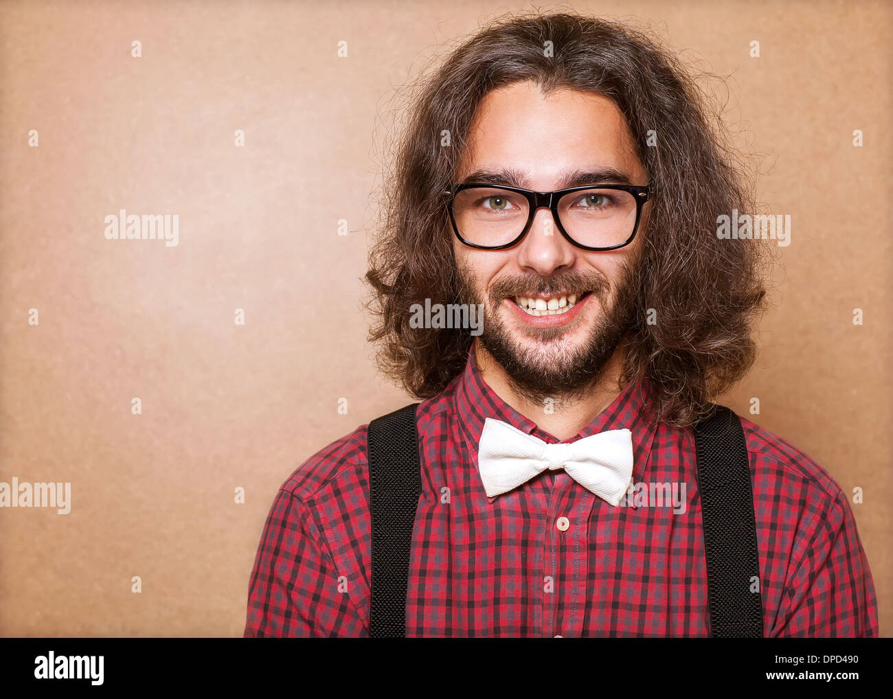 Hipster guy 's clothes in plaid shirt , suspenders and white butterfly . Close up. Studio shot Stock Photo