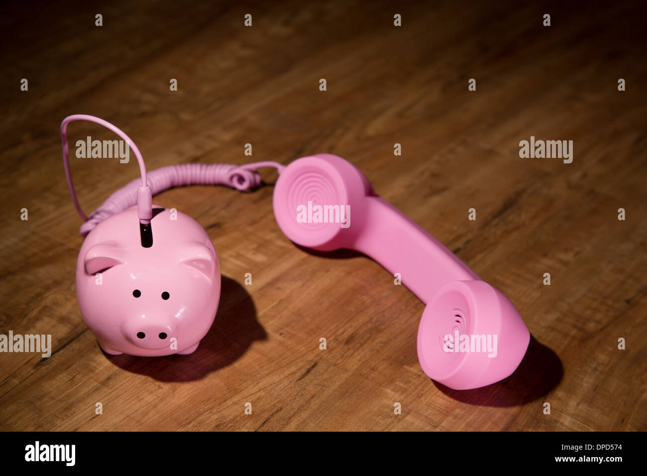 Call for help with savings - a piggy bank and a phone receiver Stock Photo
