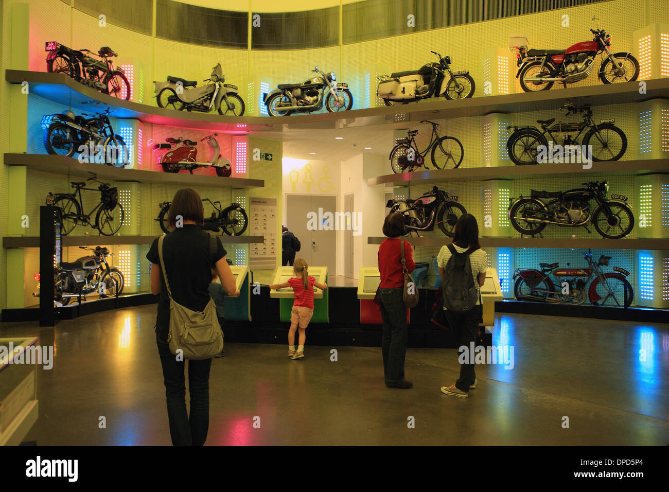 Visitors in the colourful motorbike display area of the Riverside Museum, Glasgow Stock Photo