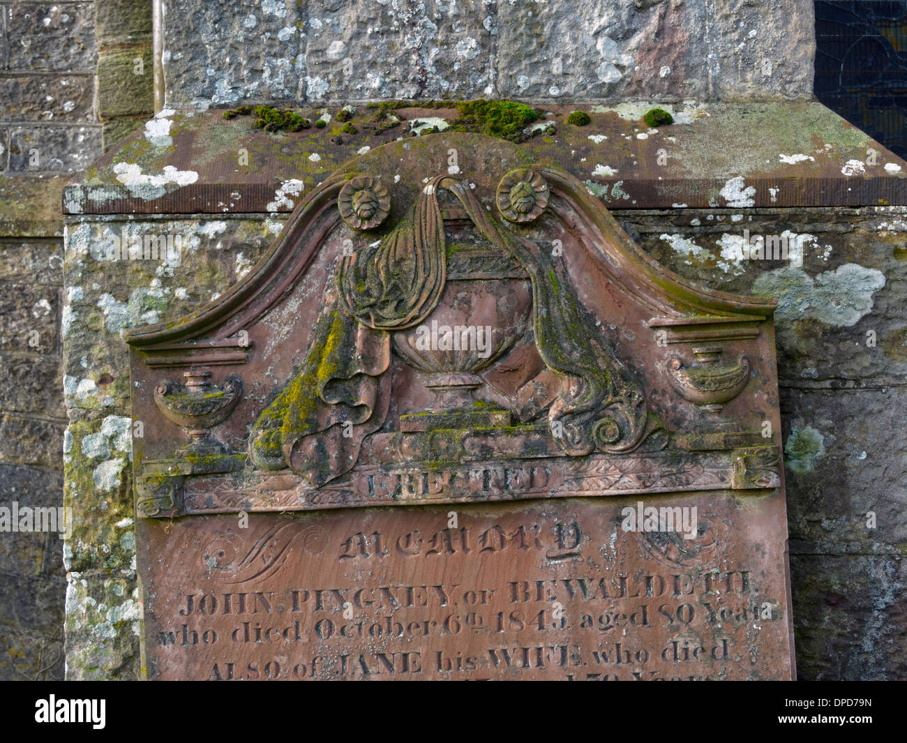 19th. century gravestone with draped urn and book design. Church of Saint Michael. Torpenhow, Cumbria, England, United Kingdom. Stock Photo