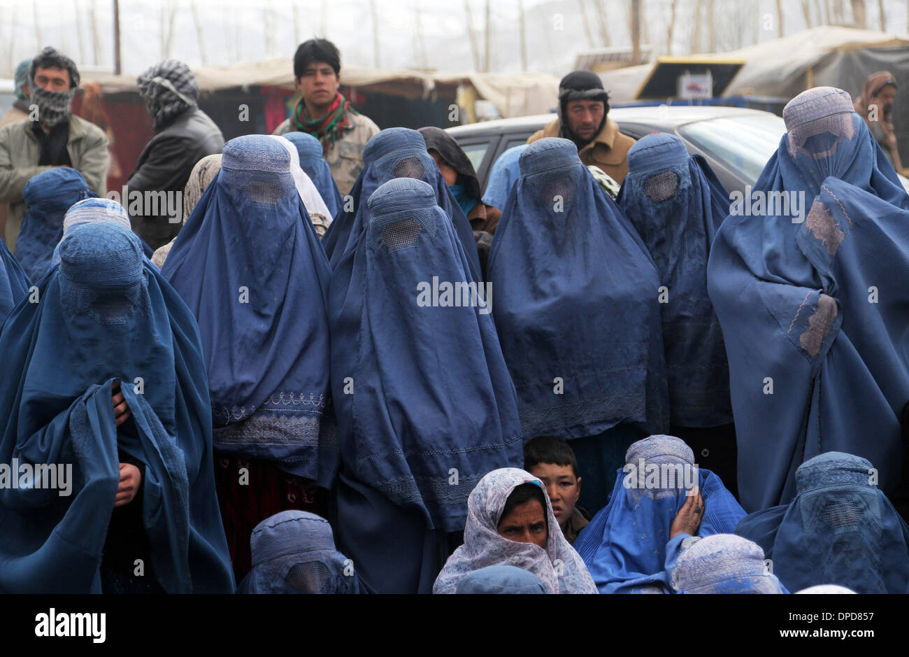 Bamyan, Afghanistan. 13th Jan, 2014. Afghan women wait to receive food donated by WFP in Bamyan province, Afghanistan, Jan. 13, 2014. Around 200 families received food from WFP in Bamyan province on Monday. Credit:  Kamran/Xinhua/Alamy Live News Stock Photo
