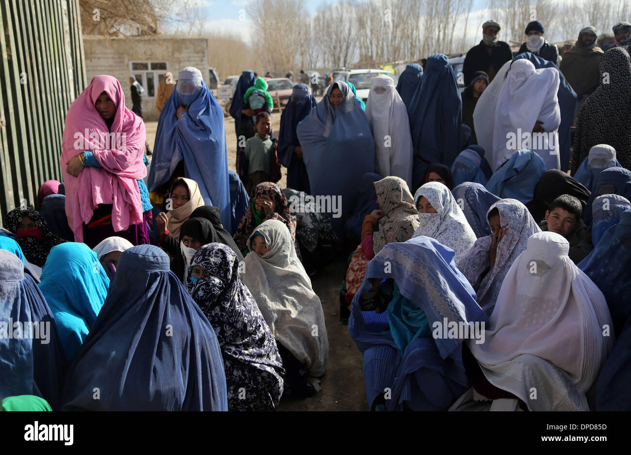 Bamyan, Afghanistan. 13th Jan, 2014. Afghan women wait to receive food donated by WFP in Bamyan province, Afghanistan, Jan. 13, 2014. Around 200 families received food from WFP in Bamyan province on Monday. Credit:  Kamran/Xinhua/Alamy Live News Stock Photo