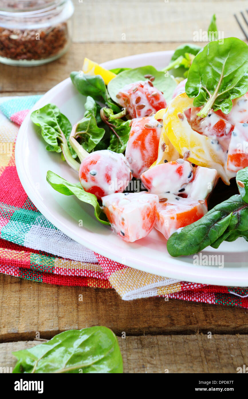 fresh salad of peppers, tomatoes with Greek yogurt, food closeup Stock Photo
