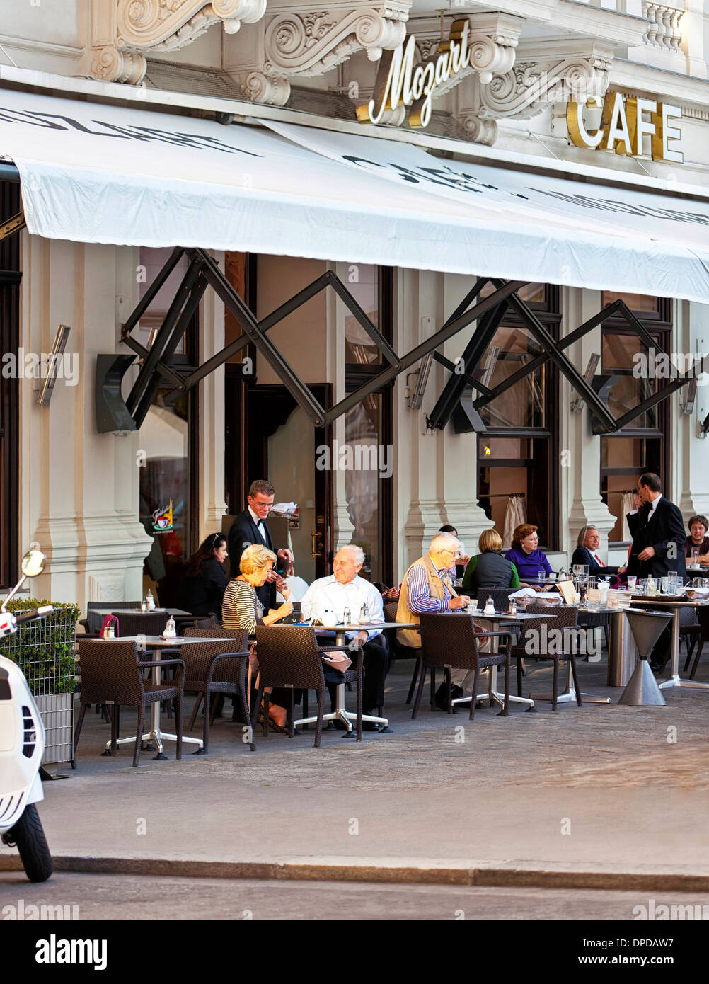 Some people enjoy a cup of coffee at the traditional Viennese Cafe Mozart  in the inner city near the State Opera of Vienna Stock Photo