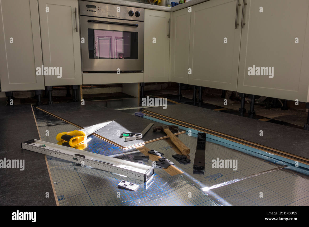 Installing laminate flooring. Various tools are on the floor. UK Stock
