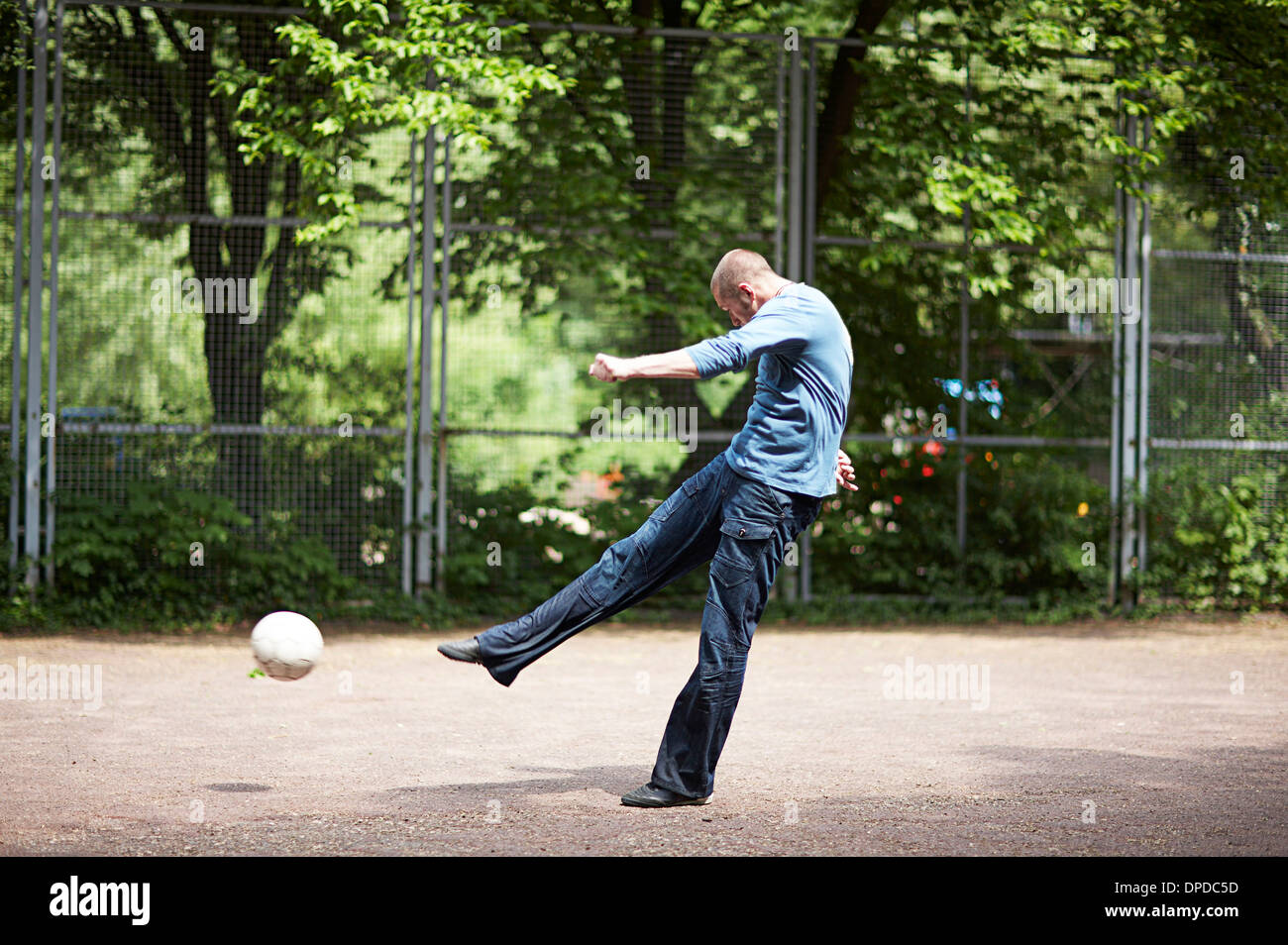 Soccer player kicking ball on soccer pitch Stock Photo Alamy