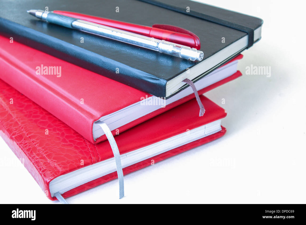 notebooks isolated pen pencil office supplies'  red black isolated white nobody objects Stock Photo