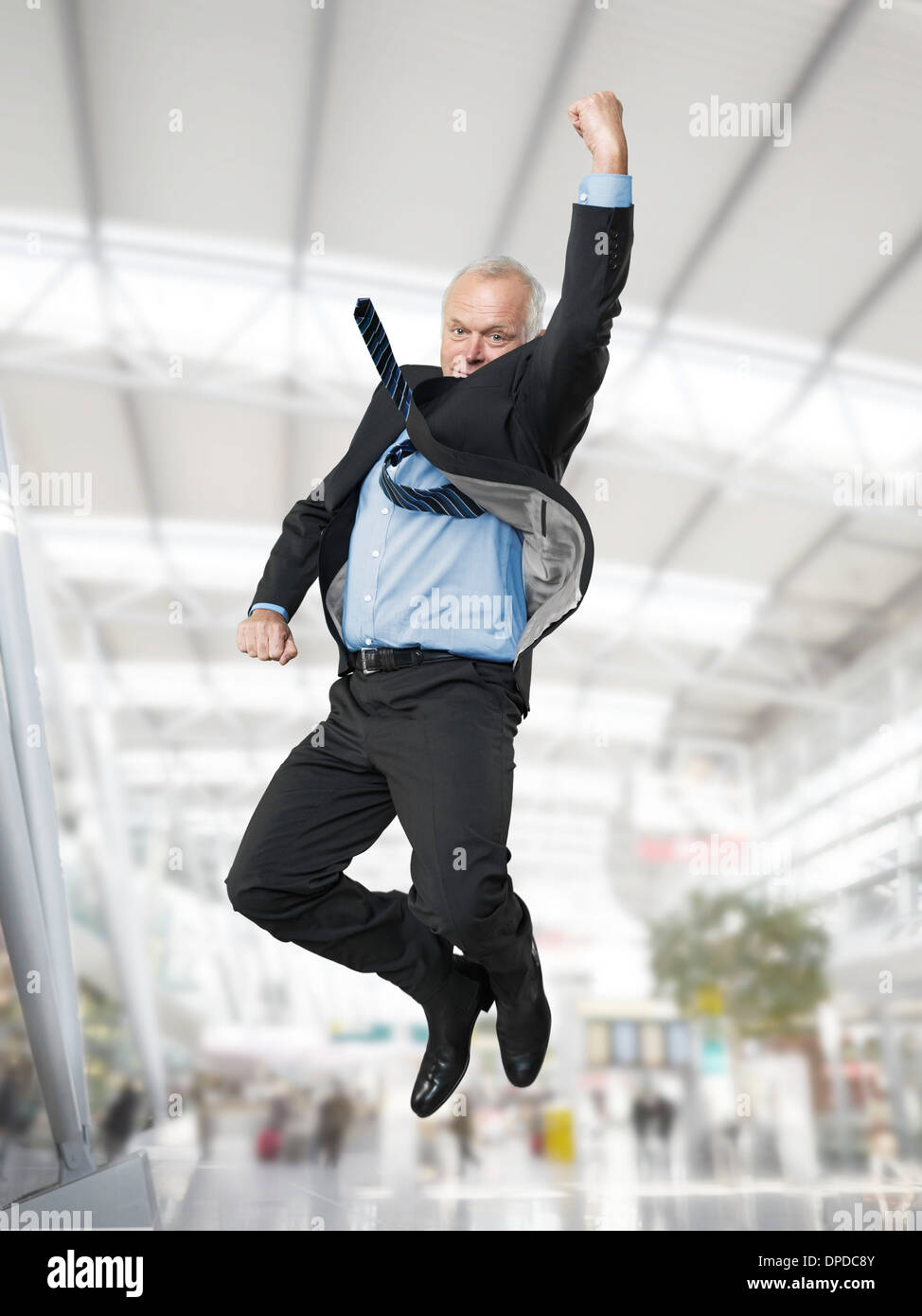 Senior businessman cutting a caper Stock Photo Alamy