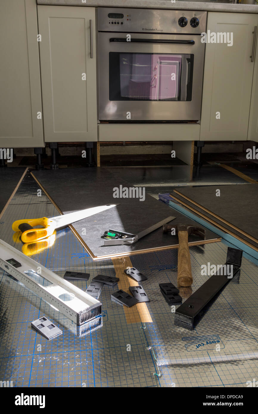 Installing laminate flooring. Various tools are on the floor. UK Stock