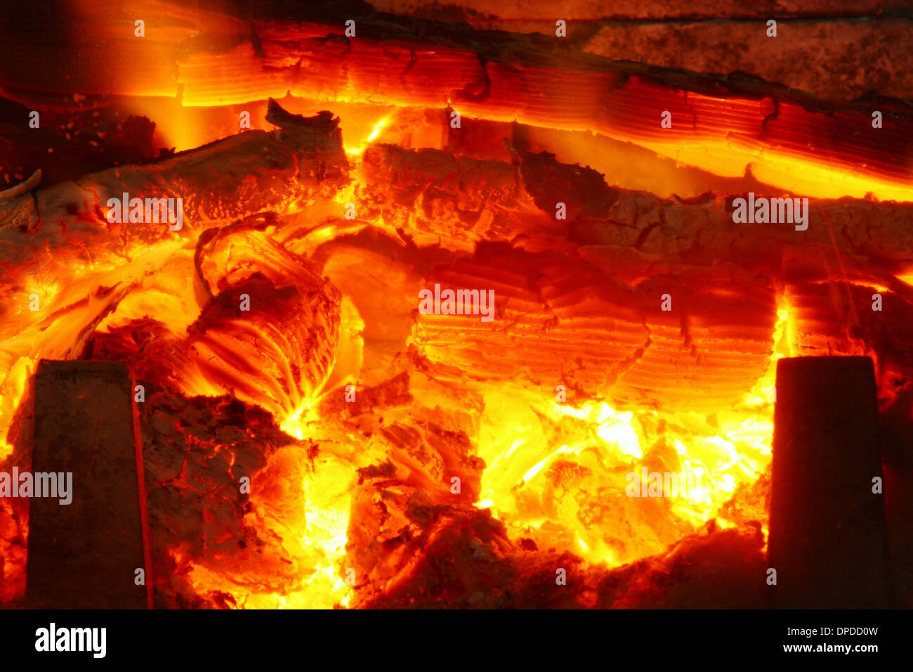 Red hot wood glowing as it burns in a domestic wood burner Stock Photo