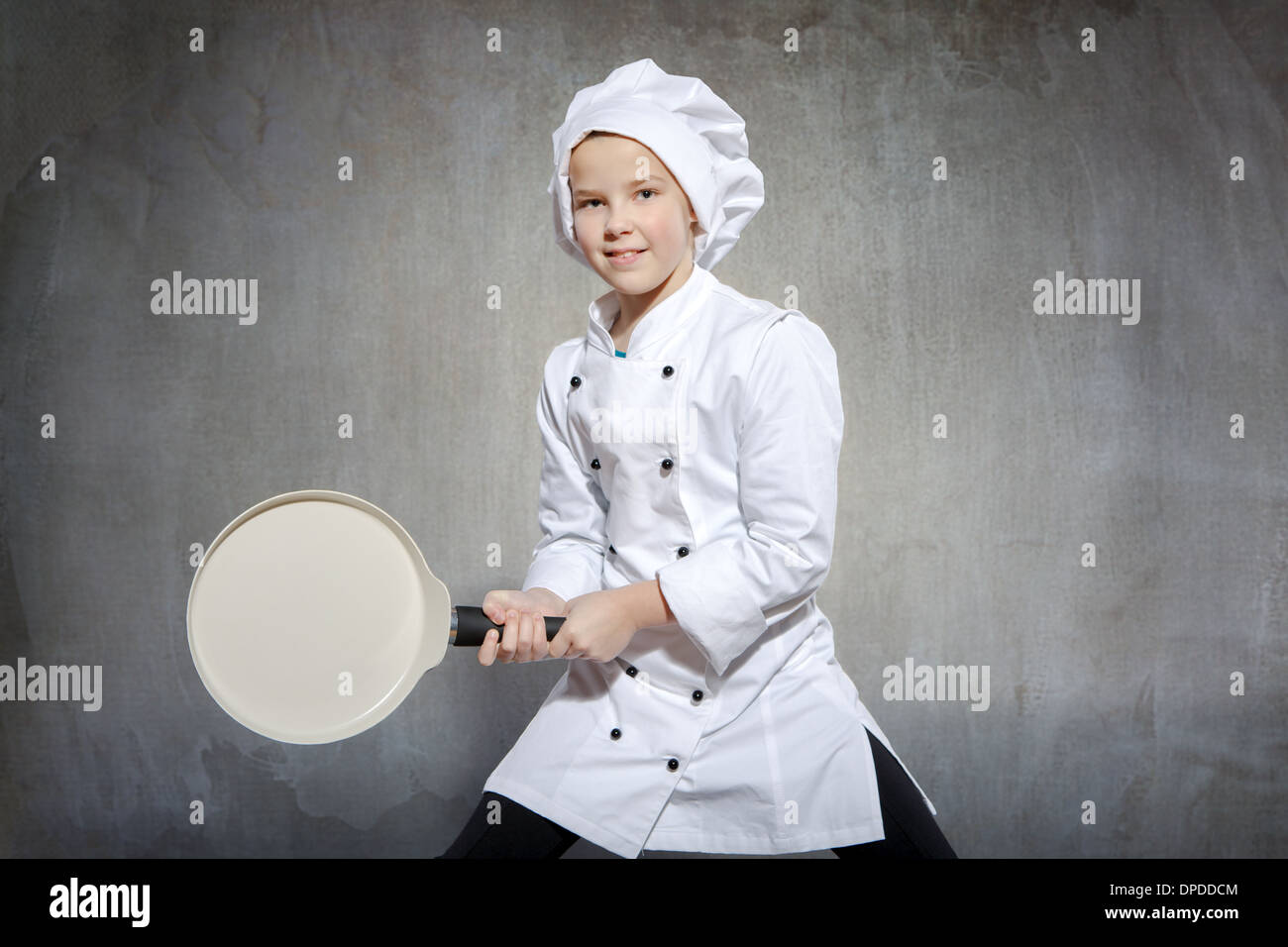 young female cook with a frying pan and egg Stock Photo