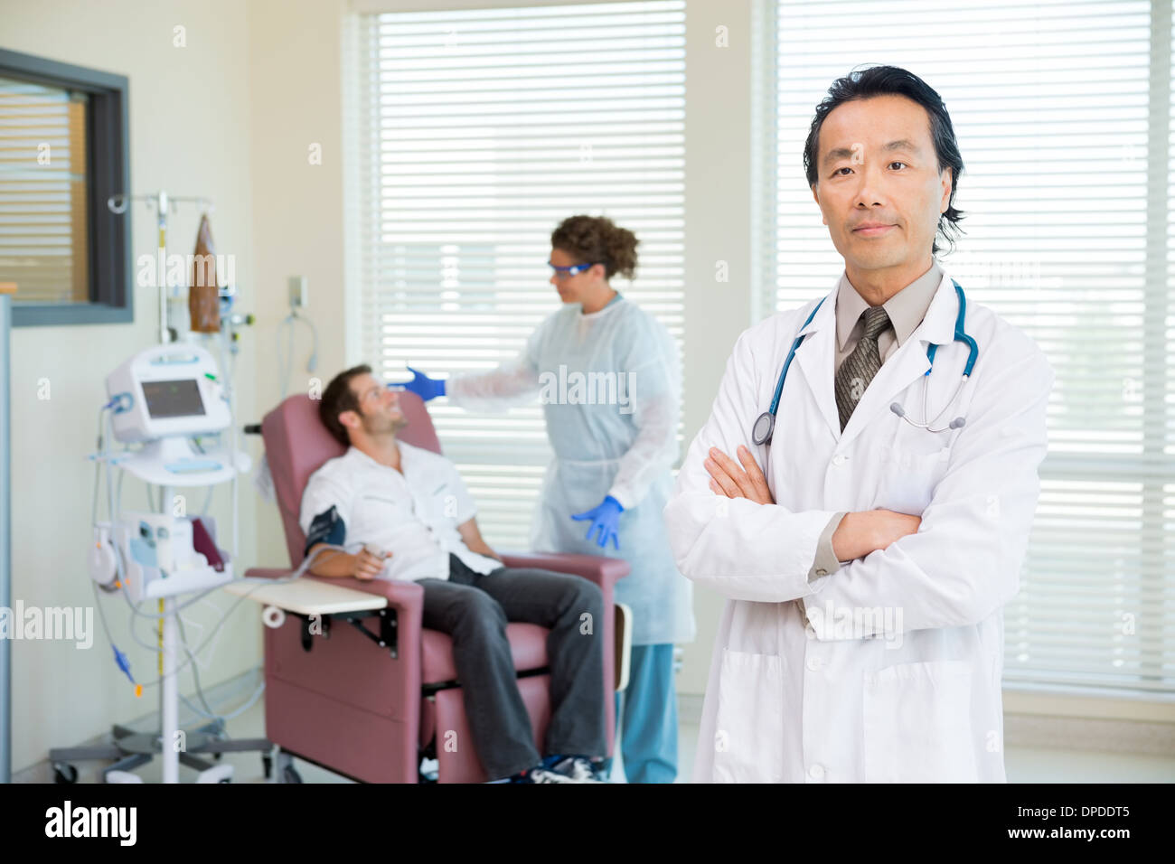 Doctor With Patient Being Examined By Pulse Rate Machine Stock Photo