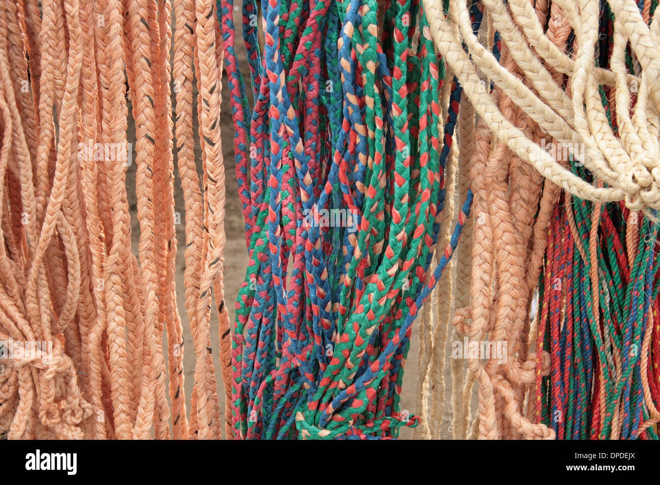 Braided rope in a variety of colors for sale at the outdoor market in Otavalo, Ecuador Stock Photo