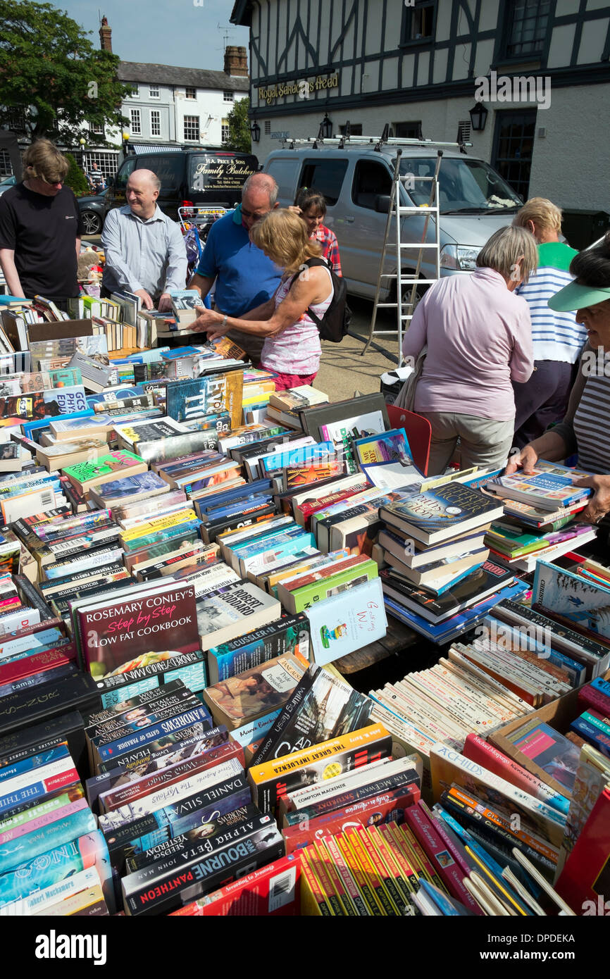 people, passersby and customers browsing secondhand books on display and for sale on a stall at Beaconsfield country fair Stock Photo