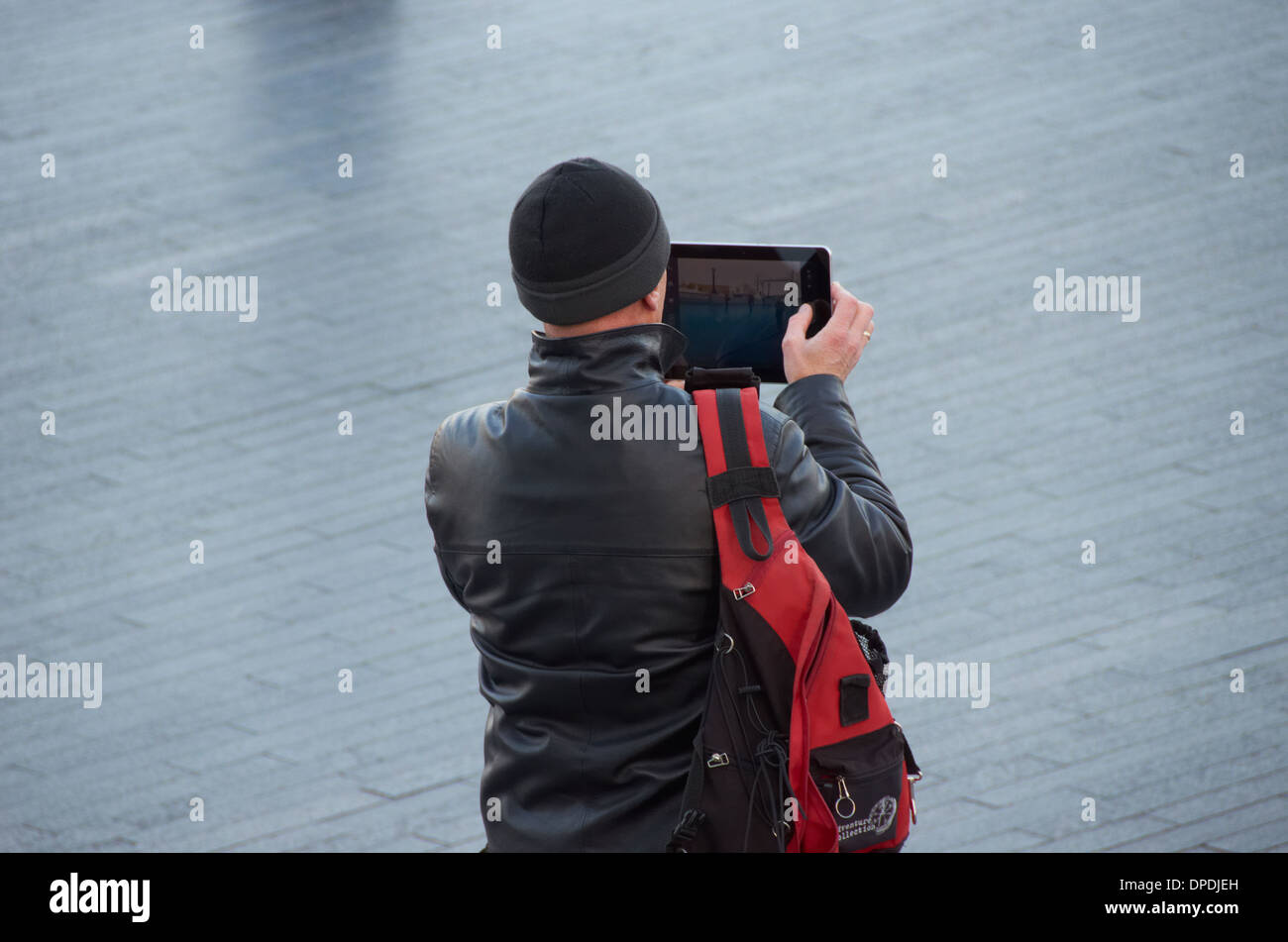 Sightseer taking a photo on an i-pad in Central London. Stock Photo