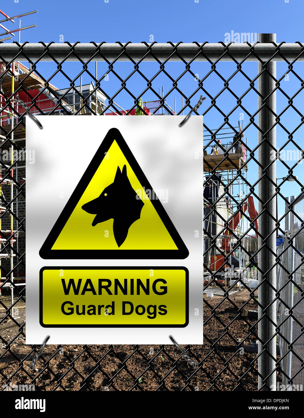 Building site security notice with ‘WARNING Guard Dogs’ sign fixed to