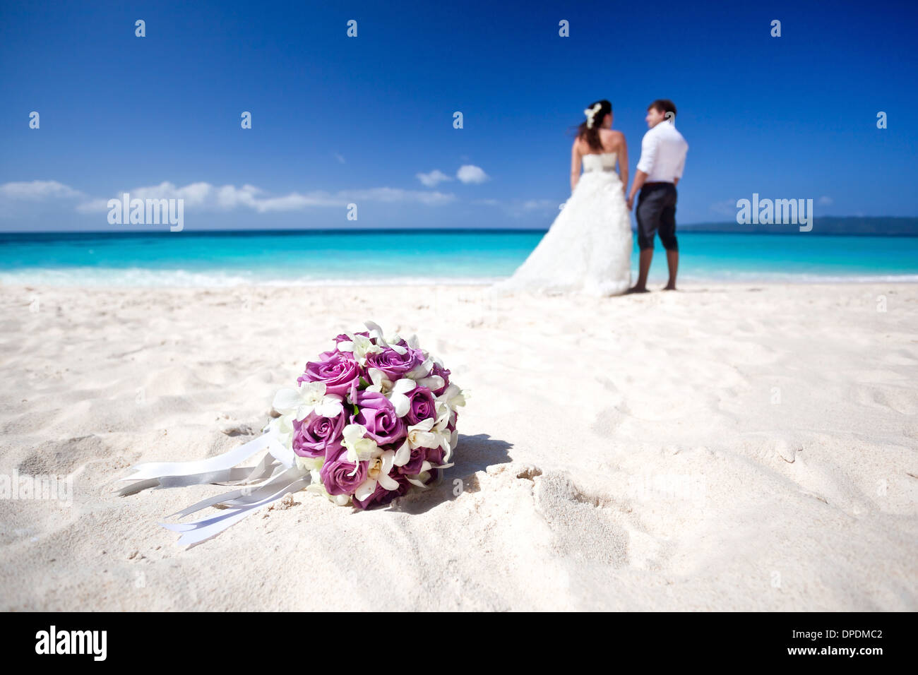 Wedding Bouquet On Wedding Couple Background Kissing At The Beach