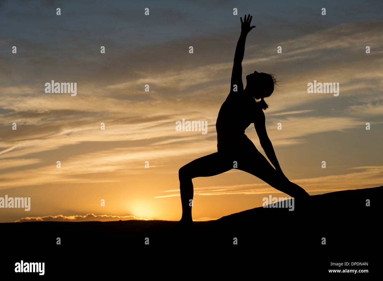 Silhouette of young woman doing yoga, Moab, Utah, USA Stock Photo Alamy