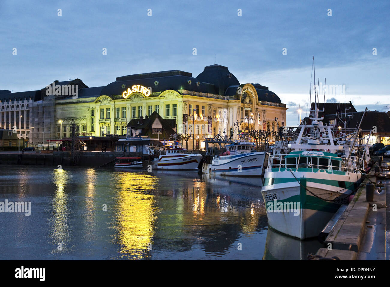 The harbur of Trouville and the casino at night - Normandy, France Stock Photo