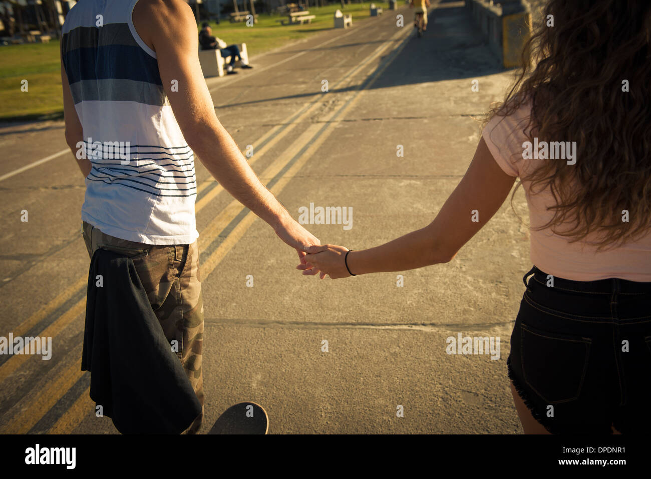 Mid section of couple holding hands Stock Photo