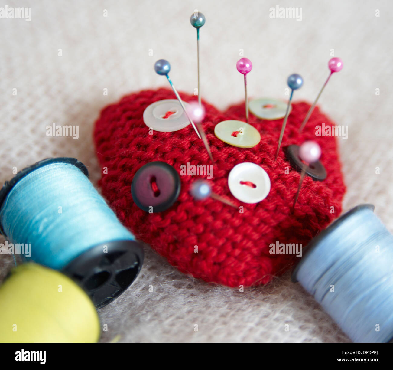 Heartshaped pin cushion. buttons and thread Stock Photo Alamy