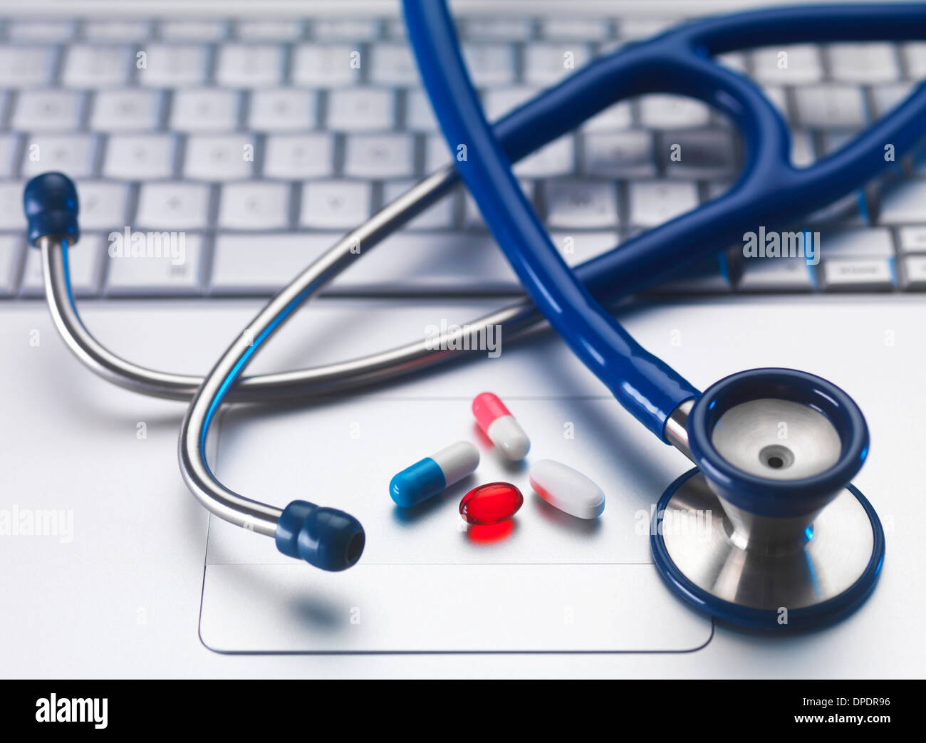 Stethoscope and medicine on laptop computer, still life Stock Photo