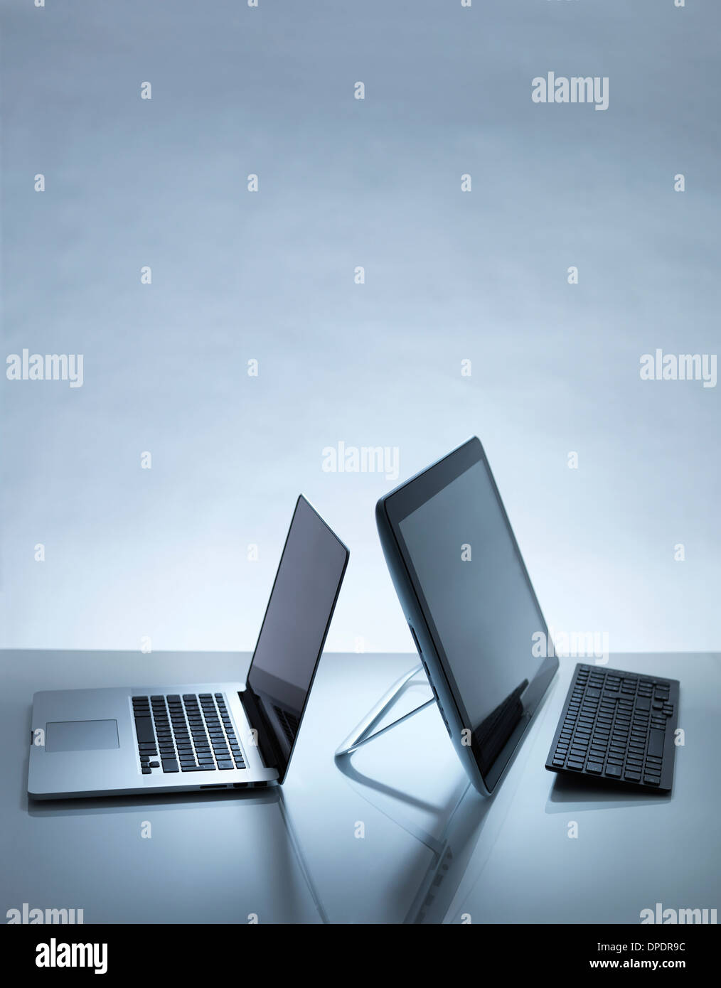 Laptop and PC on desk Stock Photo