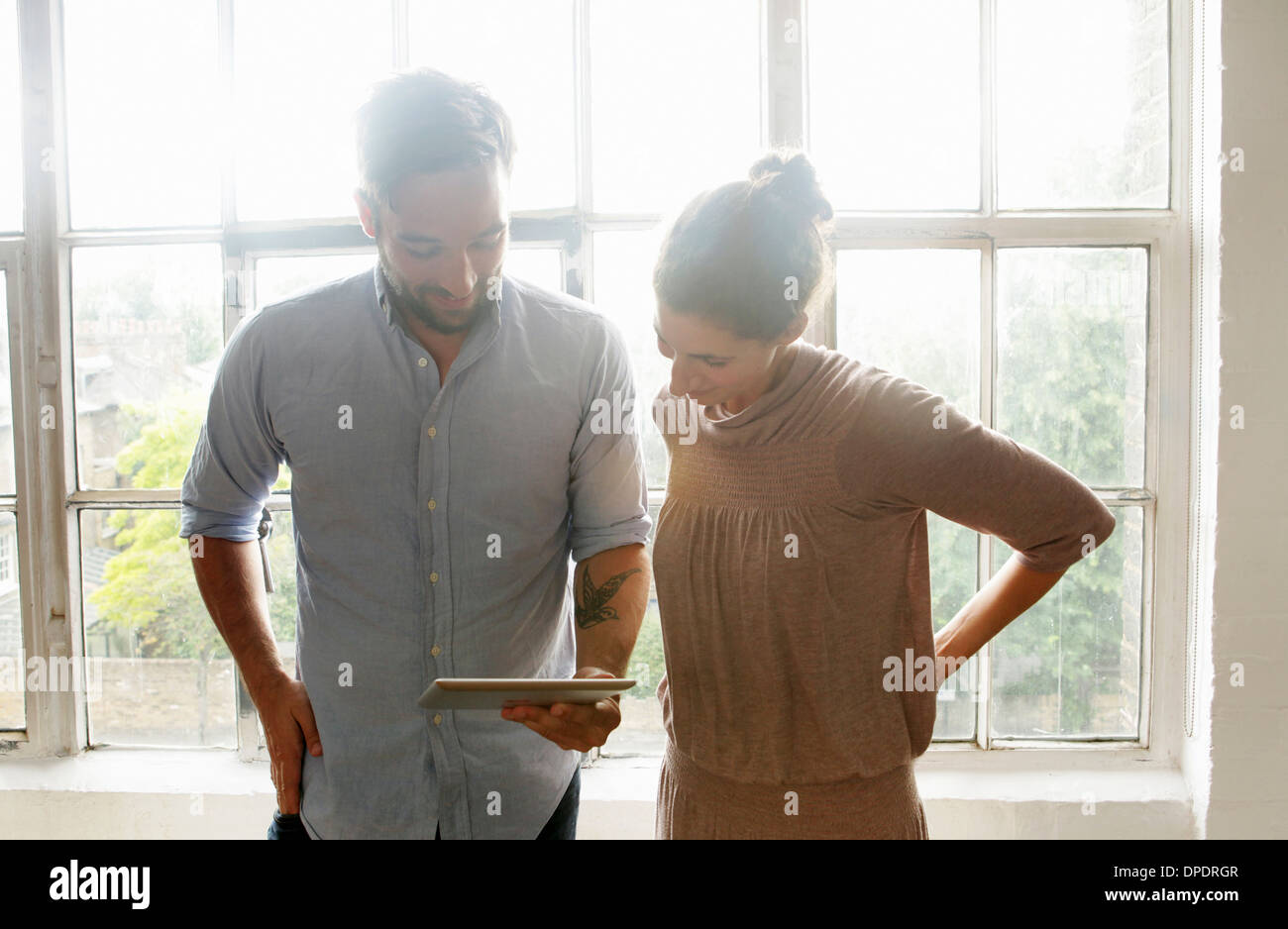 Mid adult couple using digital tablet Stock Photo