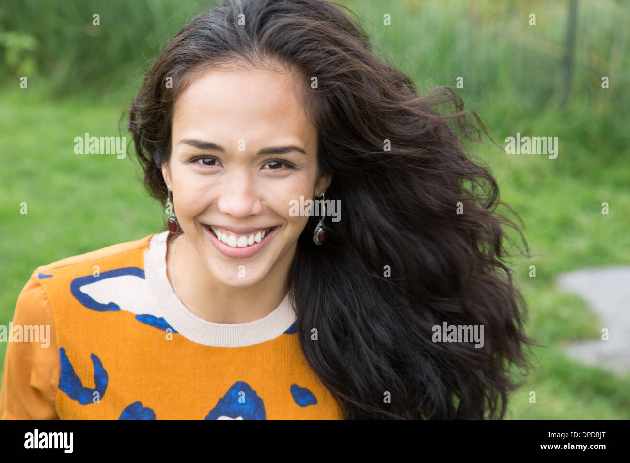 Portrait of young woman in park Stock Photo