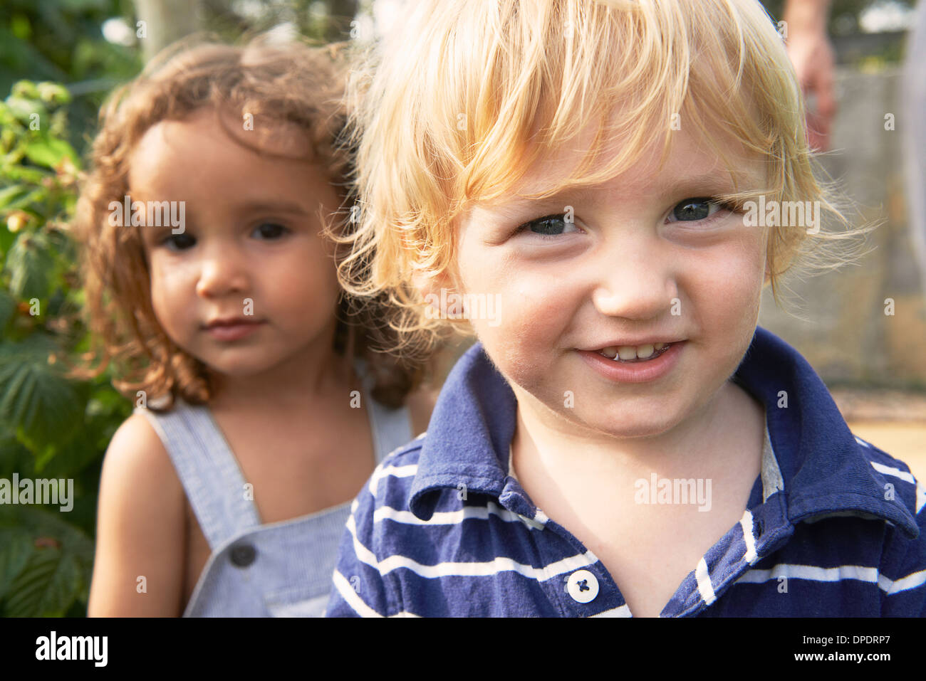 Two young boys playing in garden Stock Photo