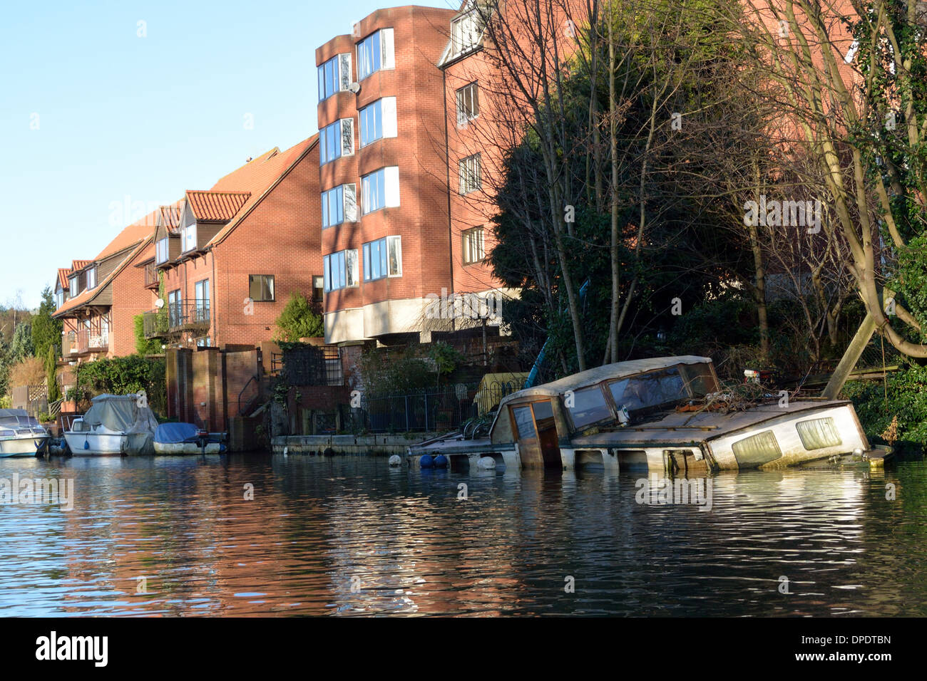 Traditional Broads cruiser sunk at her moorings in Thorpe on the outskirts of Norwich on the River Yare, Broads National Park Stock Photo