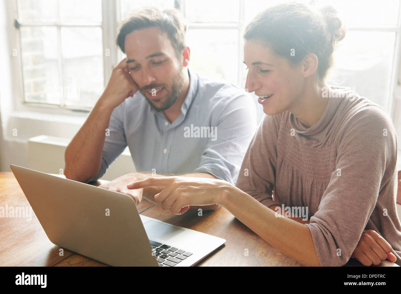 Mid adult couple using laptop Stock Photo