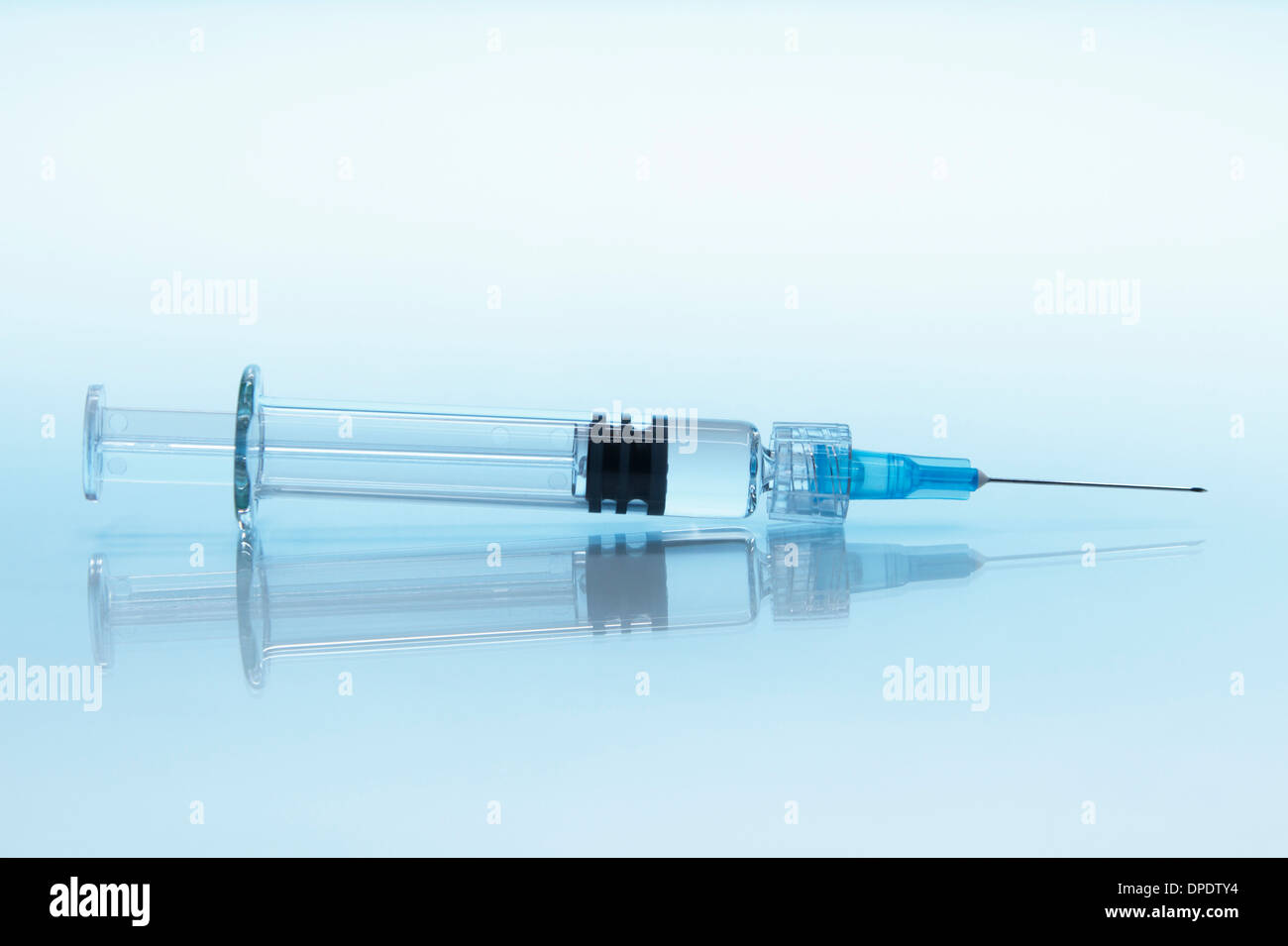 Disposable plastic medical syringe with attached hypodermic needle Stock Photo