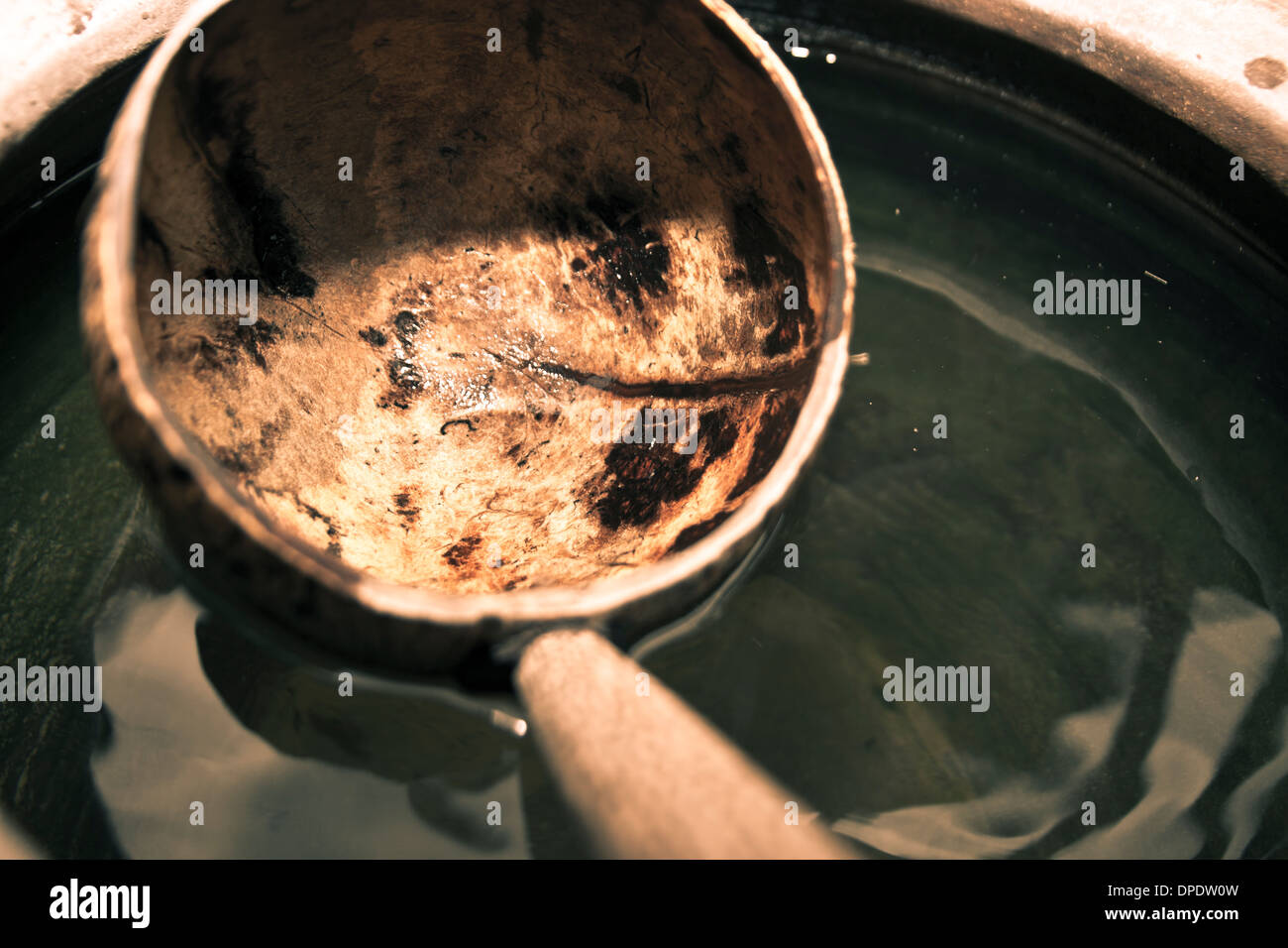 Detail of coconut shell dipper with water jar Stock Photo