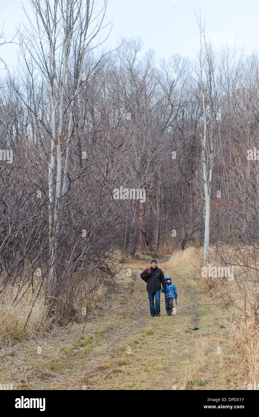 Father and son hiking in Oka National park, province of Quebec, Canada. Stock Photo