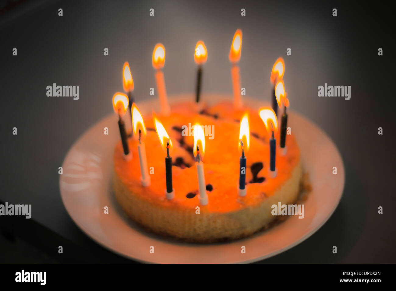 Birthday cake with candles on dark background Stock Photo - Alamy