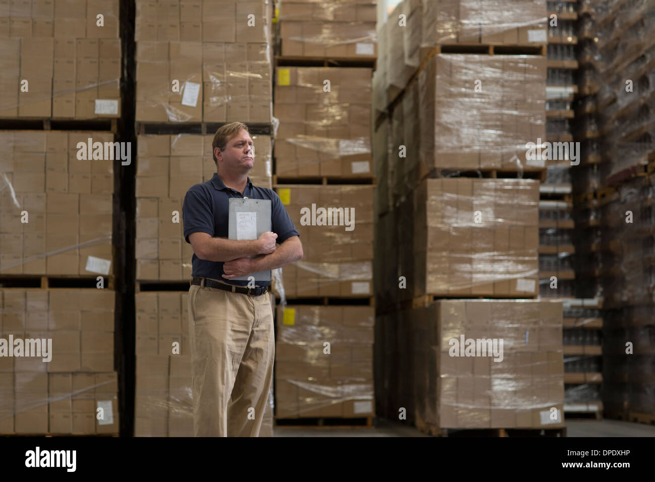 Man holding clipboard in warehouse Stock Photo