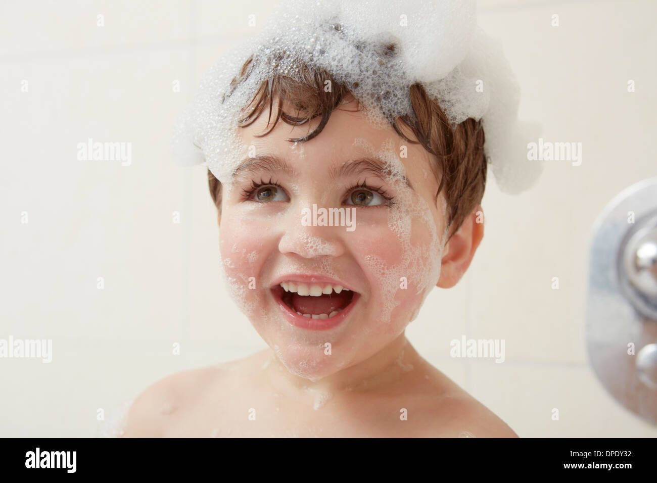 Boy in bath with bubbles on his head Stock Photo Alamy