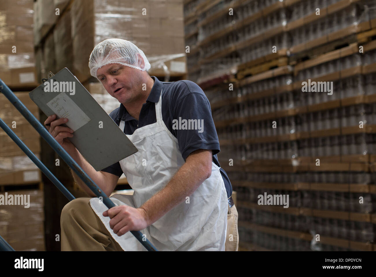 Man holding clipboard in warehouse Stock Photo