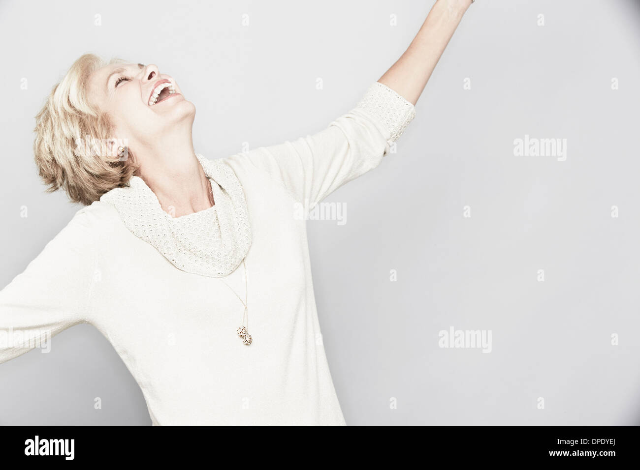 Studio portrait of senior woman laughing Stock Photo - Alamy